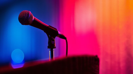 A close up photo of a microphone on a podium.