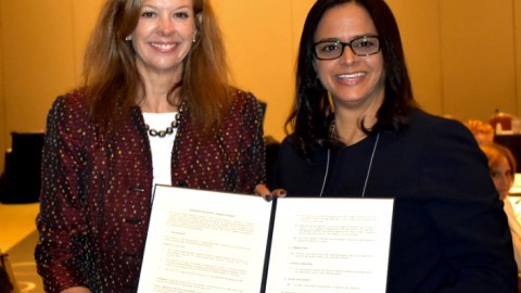 CIMA MOU Two Women Holding Signed Document