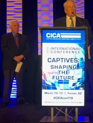 Mike ONeill accepting outstanding captive award on stage at CICA 2019 conference