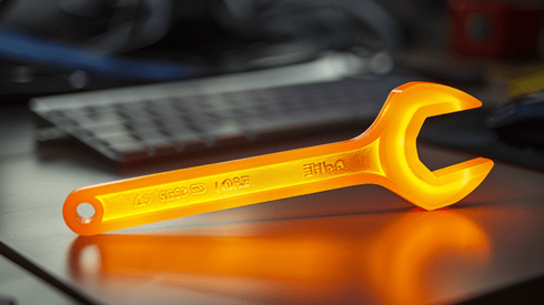 Glowing orange wrench on an office desk