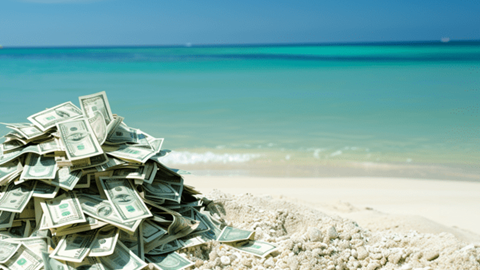 Pile of money on a beach