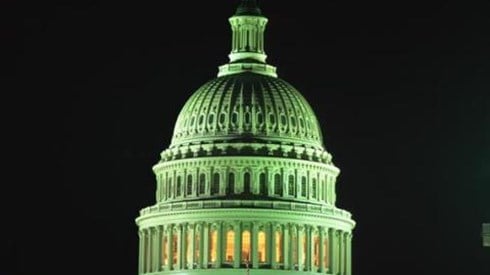 The dome of the US Senate building at night in a greenish light