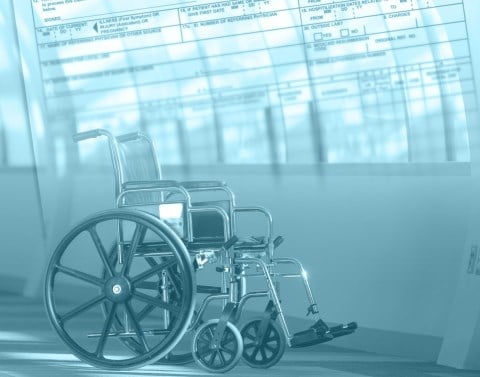 An empty wheelchair in a medical facility with medical forms superimposed in background