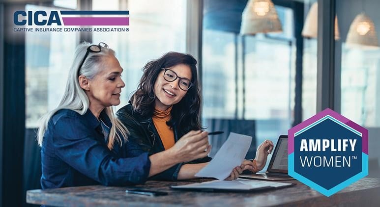 CICA Amplify Women promo of 2 businesswomen seated with the older explaining the contents of a page and a laptop