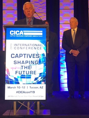 Bill McIntyre accepting outstanding captive award on stage at CICA 2019 conference