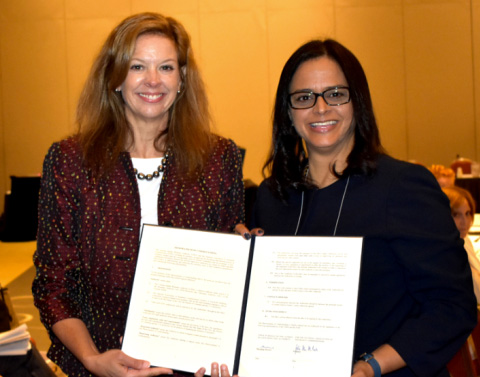 CIMA MOU Two Women Holding Signed Document