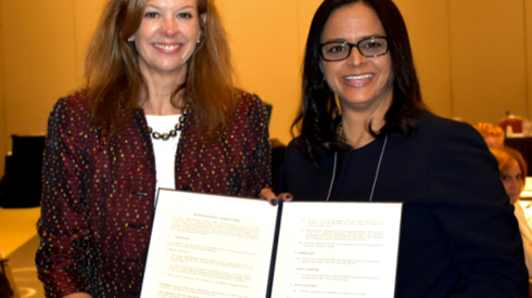 CIMA MOU Two Women Holding Signed Document