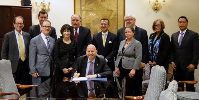 1000 Captive Commissioner Stewart and Gov Markell 11-9-2015 Cropped Captive Commissioner Karen Stewart and Governor Jack Markell licensing Delaware's 1000th captive on November 9th 2015
