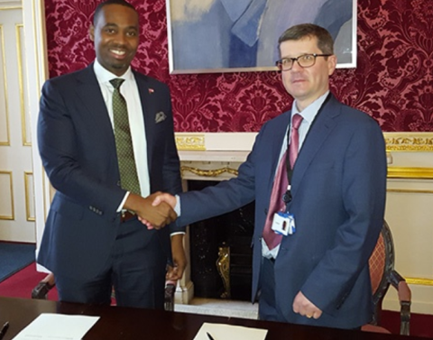 Two representatives signing the Bermuda-UK Competent Authority Agreement