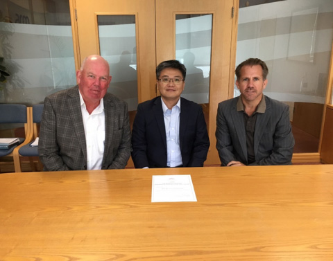 Three businessmen sitting at a board table