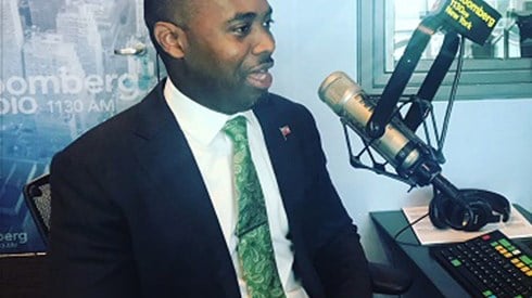 David Burt In Dark Suit Speaking In A Radio Station