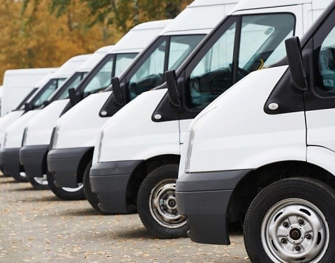 White commercial delivery vans parked in a row