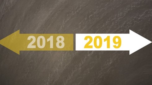 A yellow arrow with the year 2018 is pointing to the left and a white arrow with the year 2019 is pointing to the right