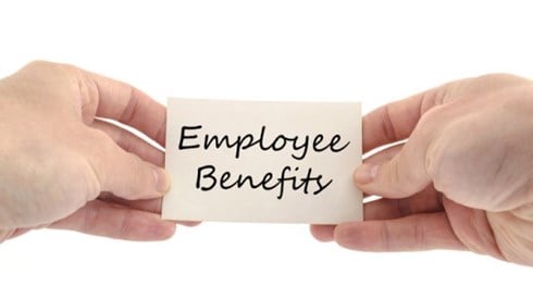 Two hands hold a small note printed with the words Employee Benefits