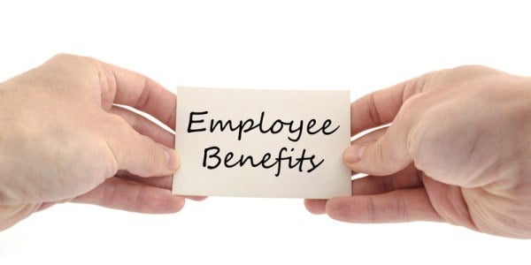 Two hands hold a small note printed with the words Employee Benefits