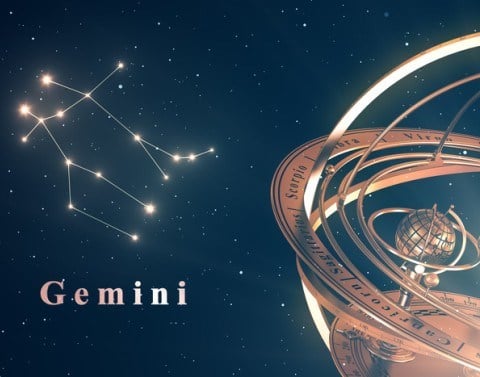 Night sky with bright stars and lines connecting the gemini constellation, with the word "gemini" and a gold zodiac globe