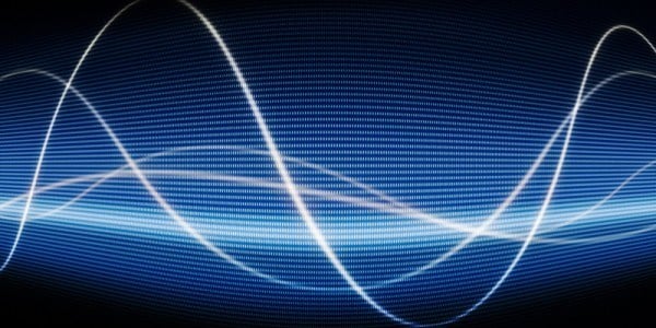 Graph abstract with 4 white curvy lines overlapping running on top of a wide band of blue digits with a black background