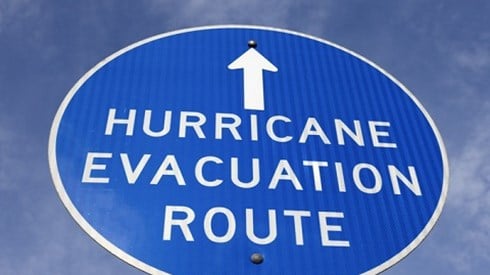 Image of blue "Hurricane Evacuation Route" sign against blue sky