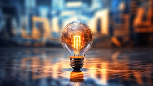 Glowing Light Bulb with Geometric Surface and Background Illustrating Innovation