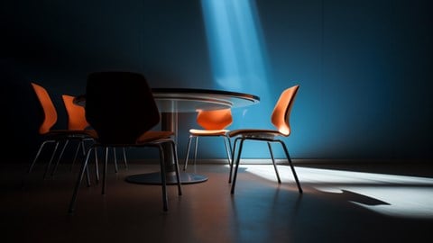 Spotlight shining on an empty chair at a table