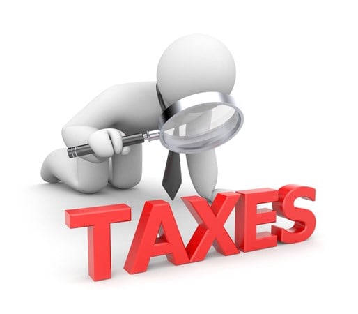A 3D bubble businessman icon uses a magnifying glass to examine red letters forming the word TAXES