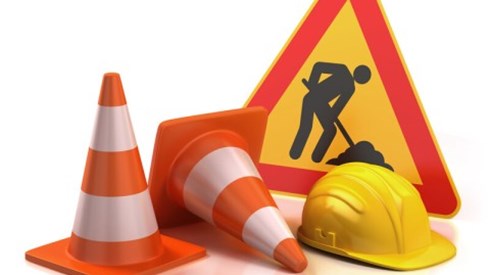 Construction sign, cones and hard hat