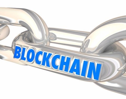 Blockchain written on the link of a chain