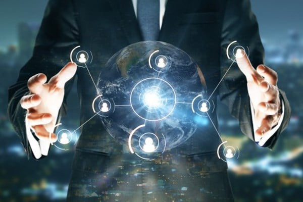 Businessman with arms out holding a white hologram of a sphere with several connecting dots