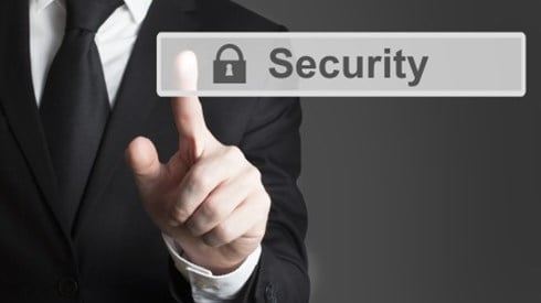Businessman in a black suit pressing finger on a small gray lightly shaded sign with the word Security and Lock in black