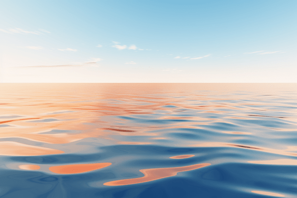 Abstract calm ocean with partially cloudy blue sky above