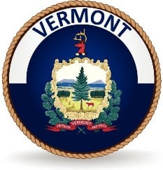 A rope circles the word VERMONT and the state flag which has the coat of arms and motto on a rectangular blue background