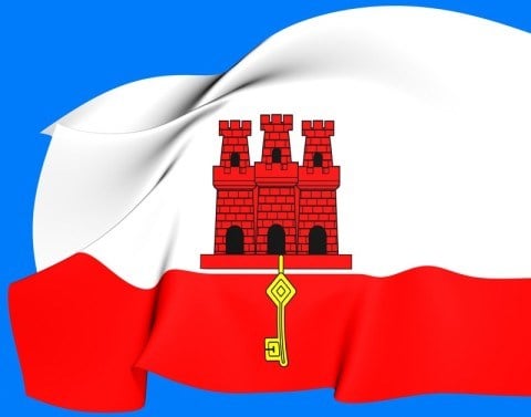 The Gibraltar flag is white with a red stripe at bottom with a three-towered red castle from which a gold key hangs