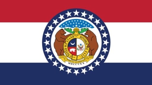 The flag of Missouri has three equal horizontal stripes of red, white, and blue with the coat of arms in the center.
