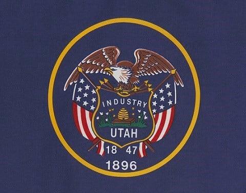 Utah flag--navy blue background, gold circle with eagle, flag, Industry, Utah, 1847, 1896 inside