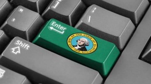 The Enter key on a computer keyboard is green and has the Washington State seal