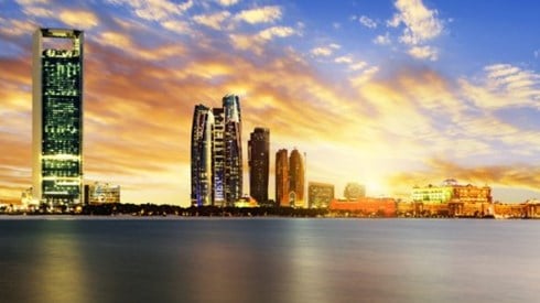 Waterfront skyline view of Abu Dhabi at sunset