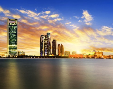 Waterfront skyline view of Abu Dhabi at sunset