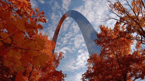 Missouri Gateway Arch during fall with red and green leaves on the trees
