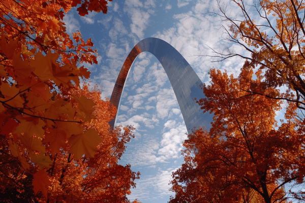Missouri Gateway Arch during fall with red and green leaves on the trees