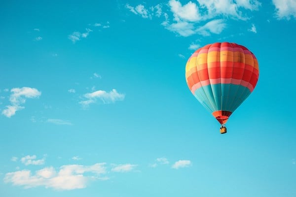 A hot air balloon against a cloudy blue sky.