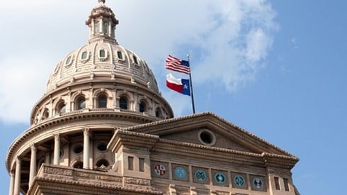 Worm´s eye view of the Texas Capitol Building with the U.S. and Texas flags