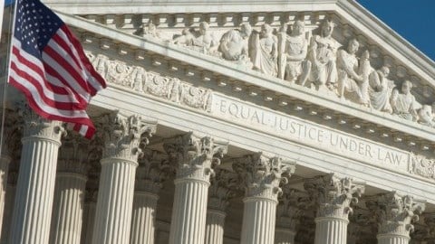 US Supreme Court building and flag