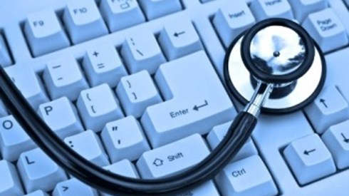 A stethoscope is lying on a computer keyboard