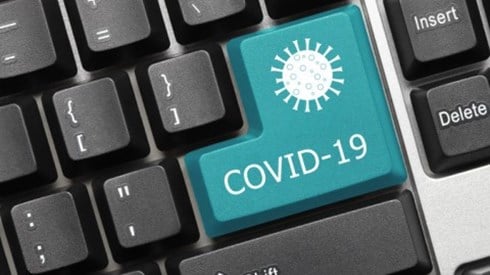 Blue COVID19 key on a black computer keyboard