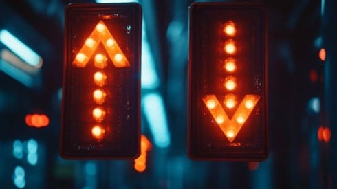two lit arrows going in opposite directions