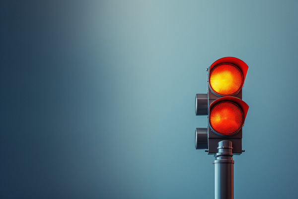Red and yellow traffic light against a blue background