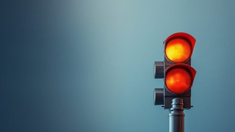 Red and yellow traffic light against a blue background