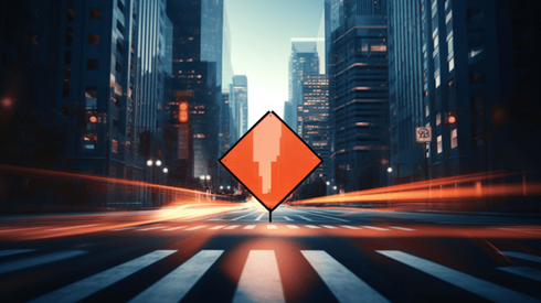 An City Street Flanked by Skyscrapers Heads Toward an Orange Road Sign Illustrating Use Caution