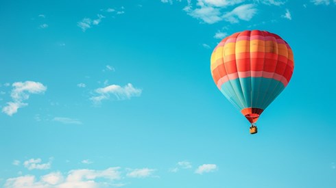 A hot air balloon against a cloudy blue sky.