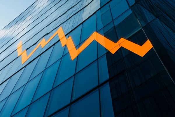 bold orange line graph declining over a blue building
